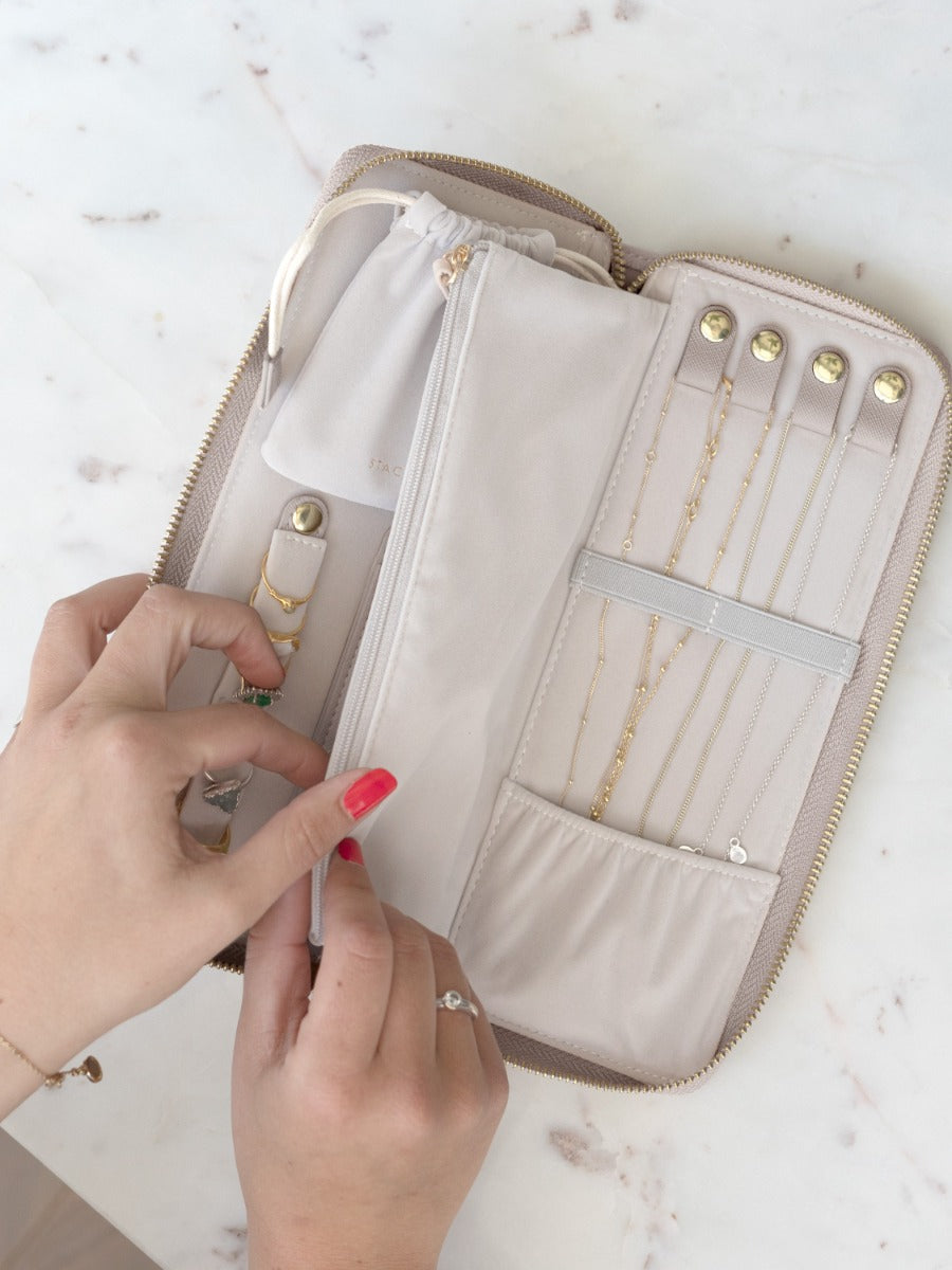 Stackers taupe jewellery roll in use, showing necklace and ring storage.