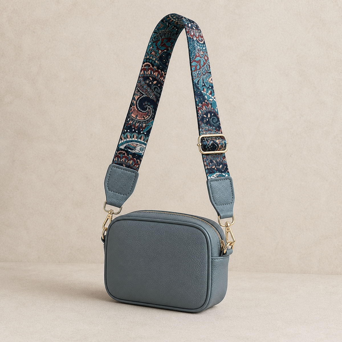 Peacock Paisley interchangeable strap styled on a slate-blue crossbody bag; bag not included