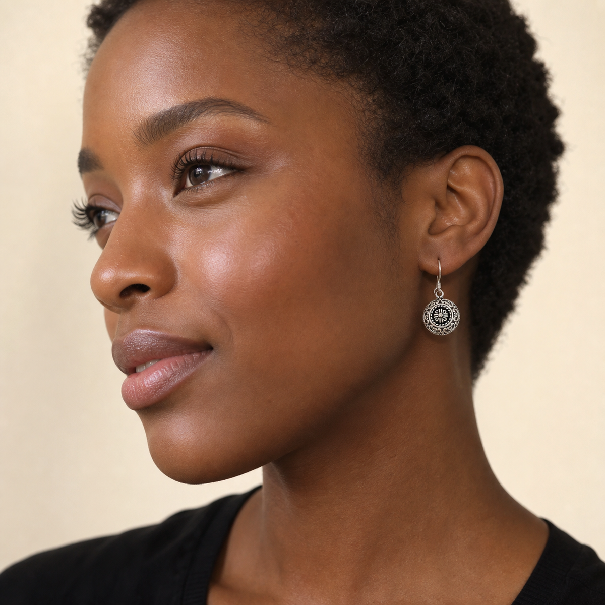 Woman wearing PJ Luxe sterling silver mandala round earrings