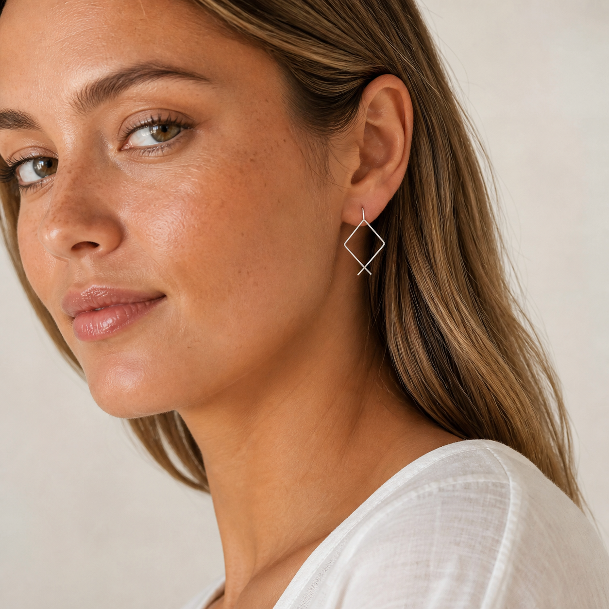 Woman wearing PJ Luxe sterling silver square threader hoop earrings