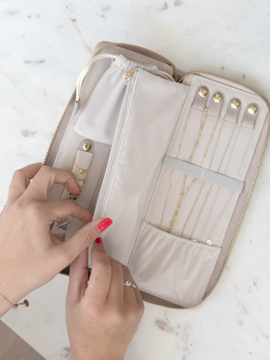 Stackers taupe jewellery roll in use, showing necklace and ring storage.