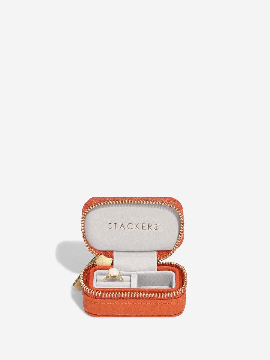 Stackers orange petite travel jewellery box open, showing ring storage and a small compartment.