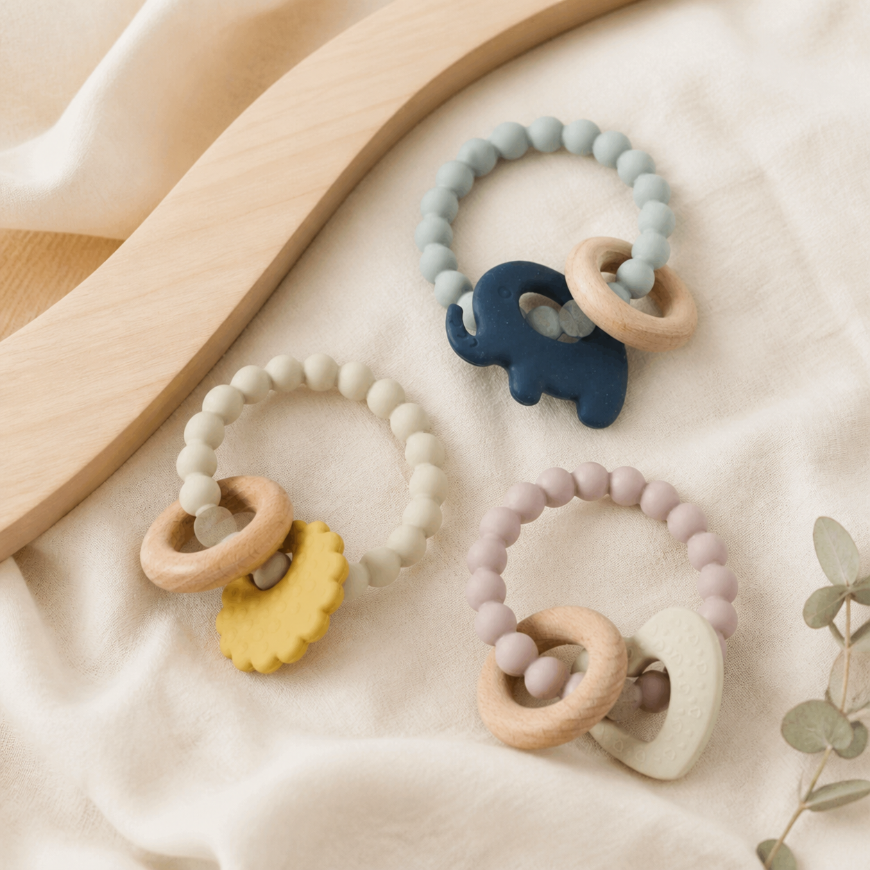PJ Luxe Mika silicone and wood baby teethers in blue natural and blush colourways