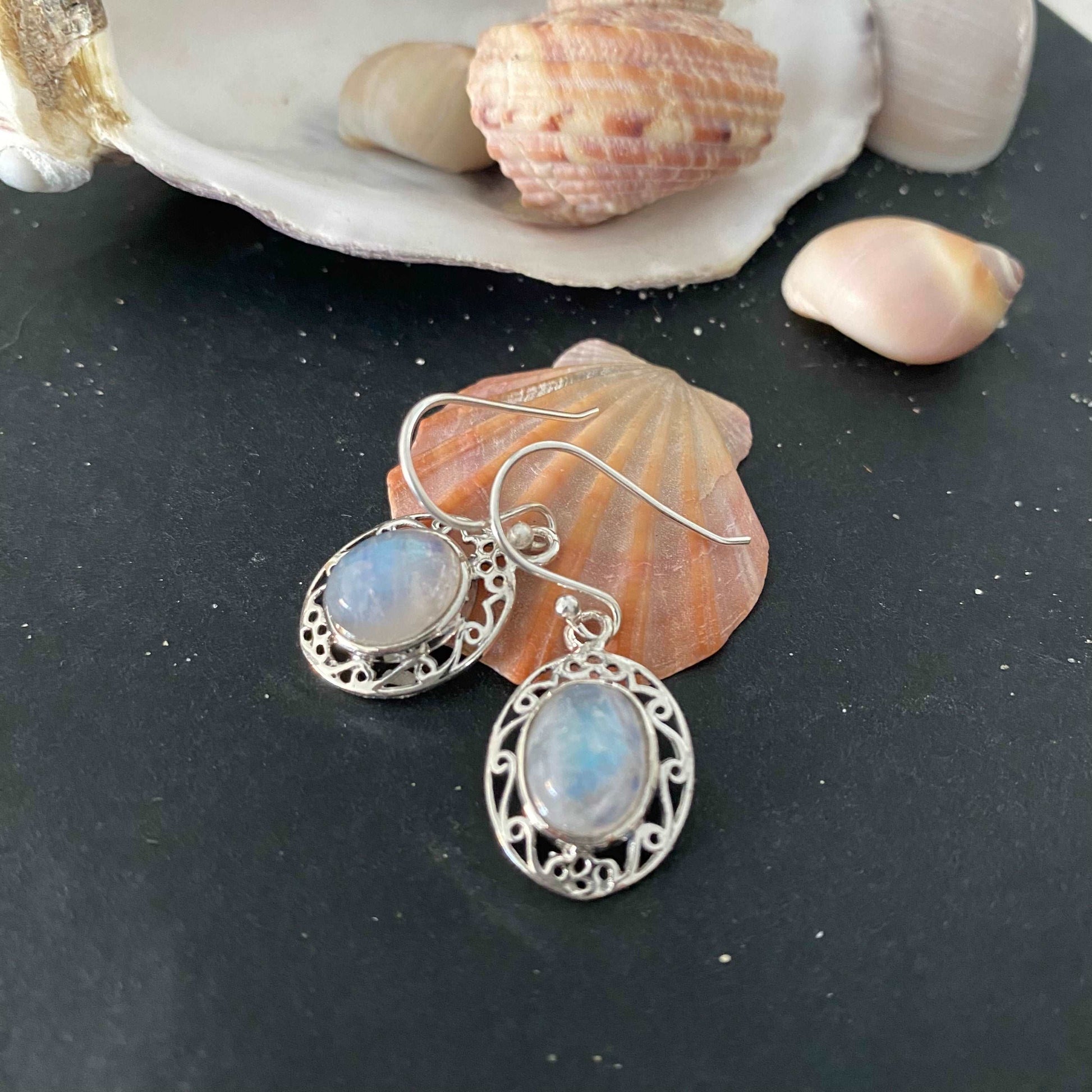 Sterling silver earrings, featuring ethereal moonstone gems that capture the light, radiating a soft, luminous glow, embodying elegance and mystique.