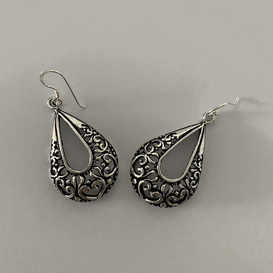 Elegant Vintage Filigree Teardrop Sterling Silver Earrings, showcasing intricate lace-like filigree patterns within teardrop frames, reflecting a refined antique aesthetic, suspended from delicate hooks.