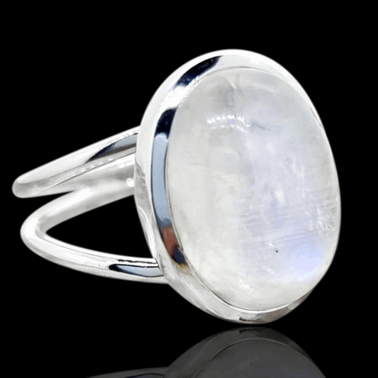 Elegant Sterling Silver Moonstone Ring, featuring a captivating oval-shaped moonstone at its center. The ring is designed with a unique split band, enhancing its visual appeal and adding a modern twist to the classic setting. The moonstone's ethereal glow is beautifully complemented by the polished sterling silver, making it a perfect piece for those who appreciate the balance of contemporary design and natural beauty.