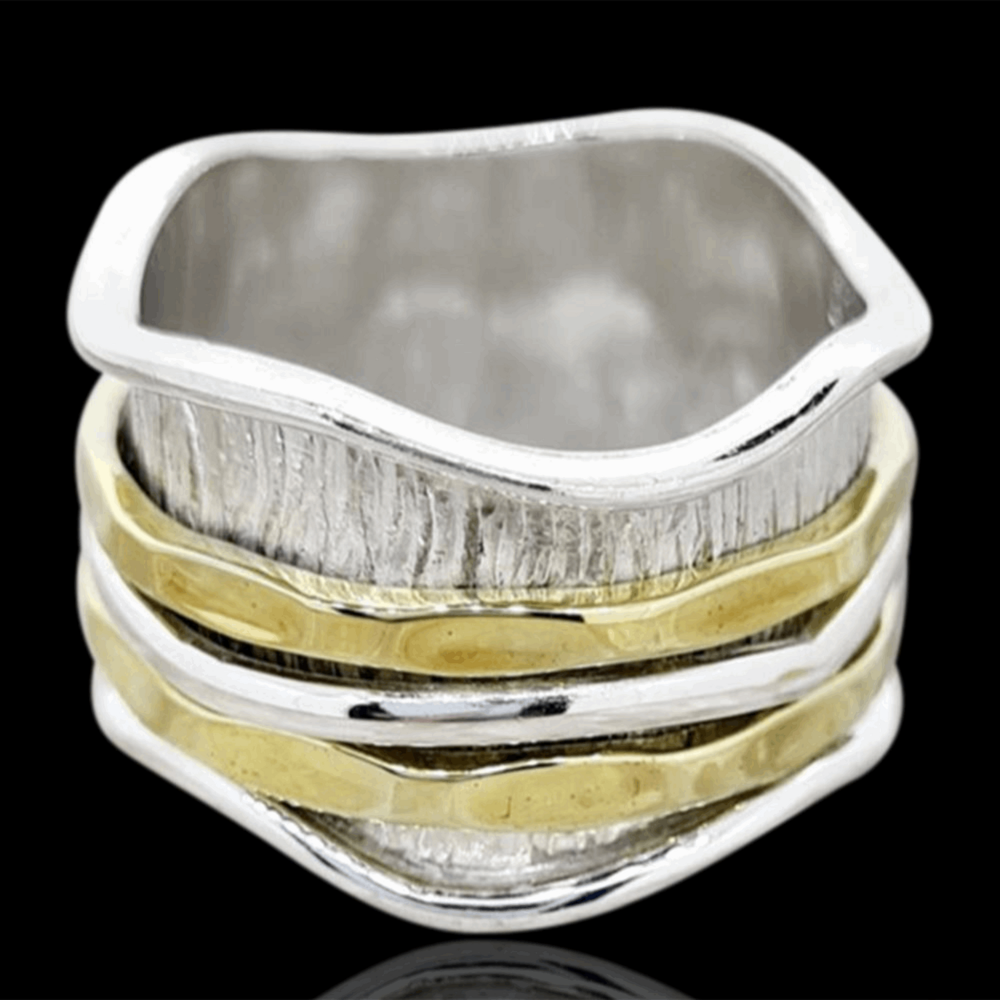 This Sterling Silver and Gold Faith Spinning/Meditation Ring beautifully marries simplicity with deep meaning. Its design features a central band inscribed with symbols or text that represents faith, encased between sterling silver edges and highlighted with gold accents. The spinning motion of the central band offers a calming effect, making it not just a piece of jewelry but a serene companion for reflection and meditation.