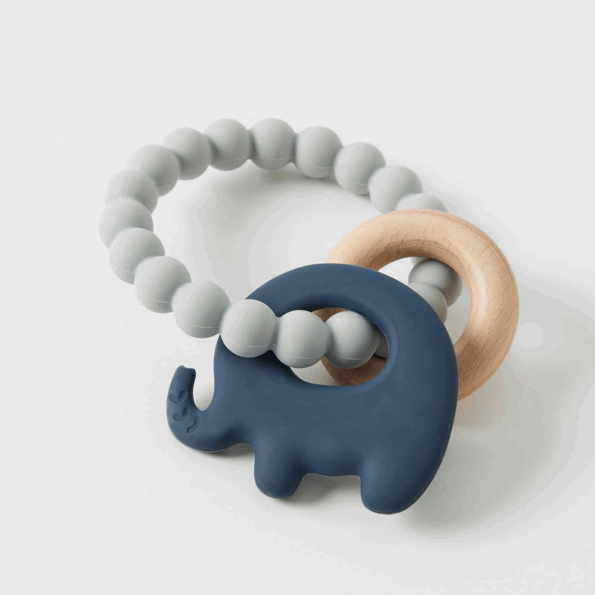 Natural and safe Mika Silicone & Wood Teether, featuring a combination of soft, BPA-free silicone beads and smooth, untreated wooden rings. Designed for soothing gums and promoting sensory development in infants.