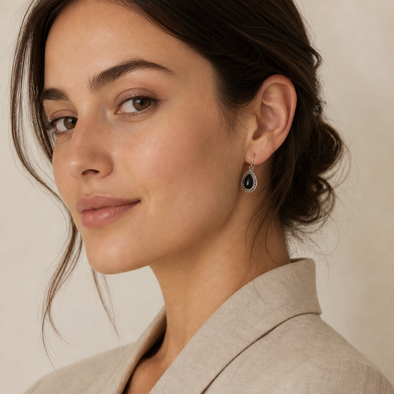 Young adult woman wearing PJ Luxe black onyx beaded teardrop sterling silver earrings
