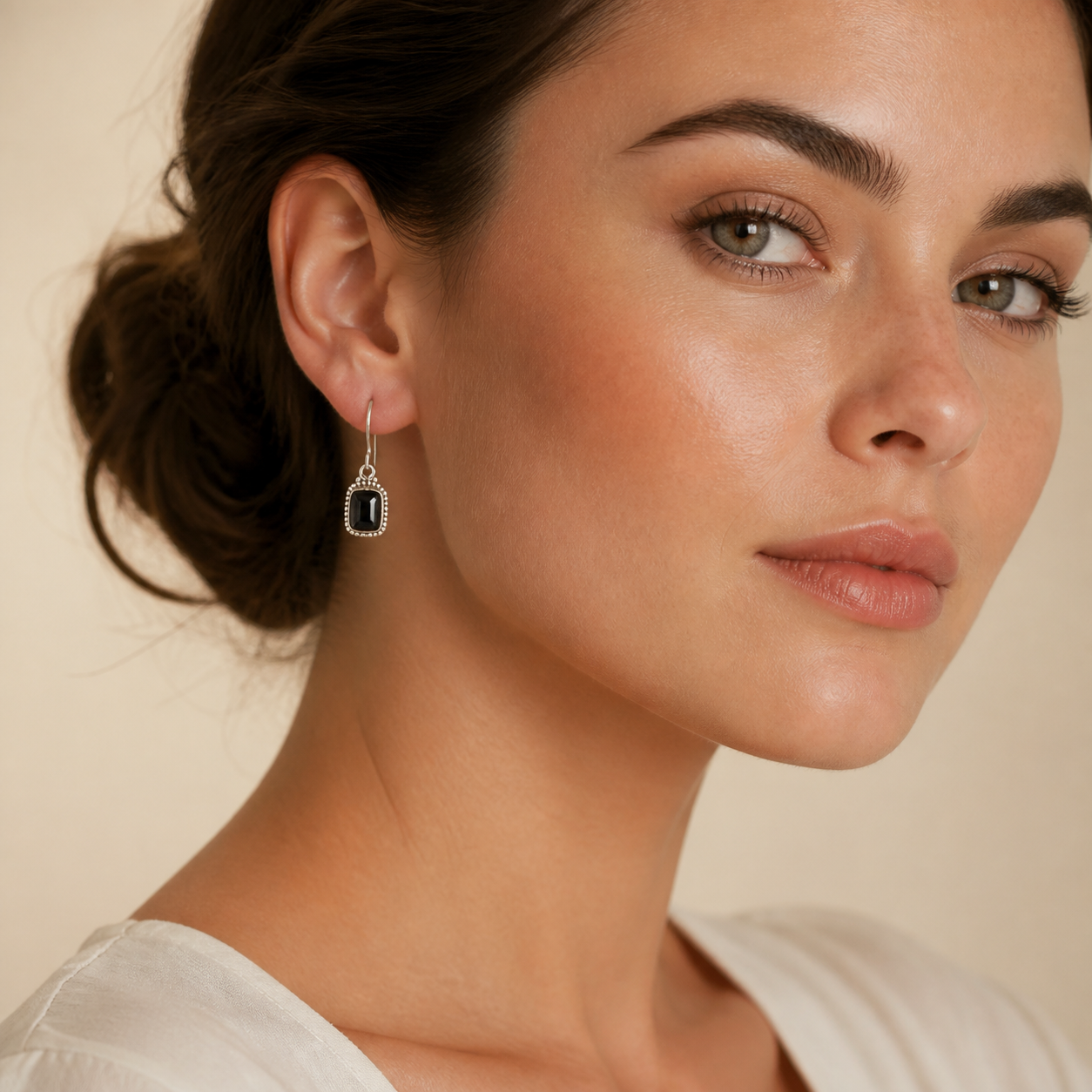 Young adult woman wearing PJ Luxe black onyx bezel-set sterling silver earrings
