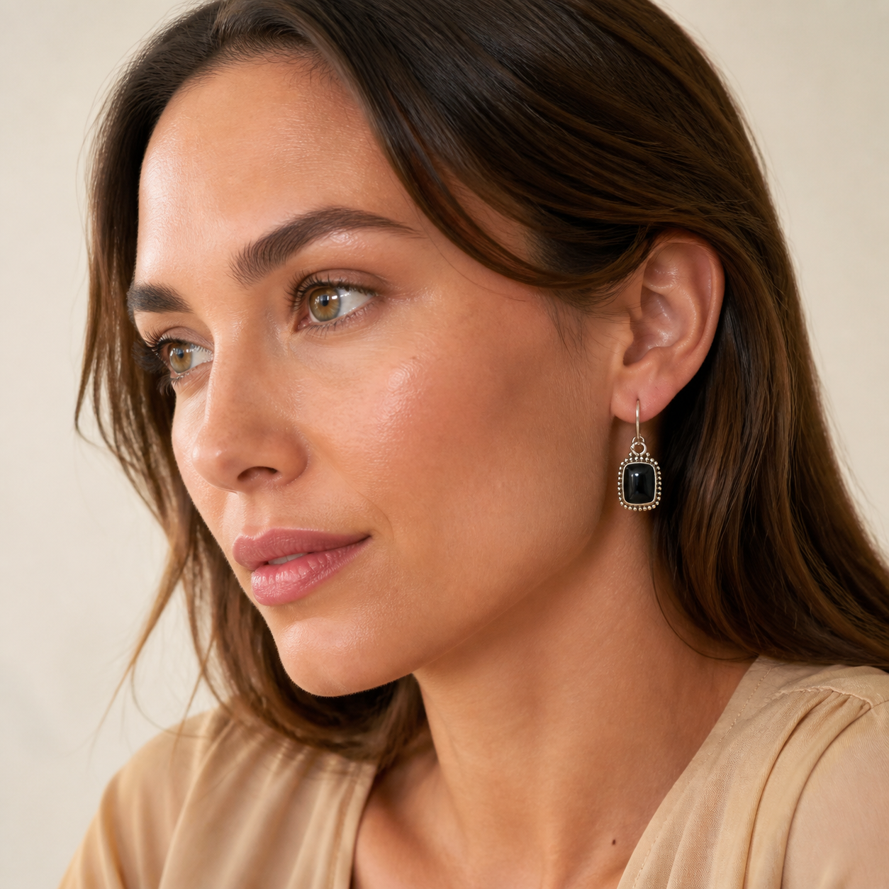 Young adult woman wearing PJ Luxe black onyx rectangle sterling silver earrings