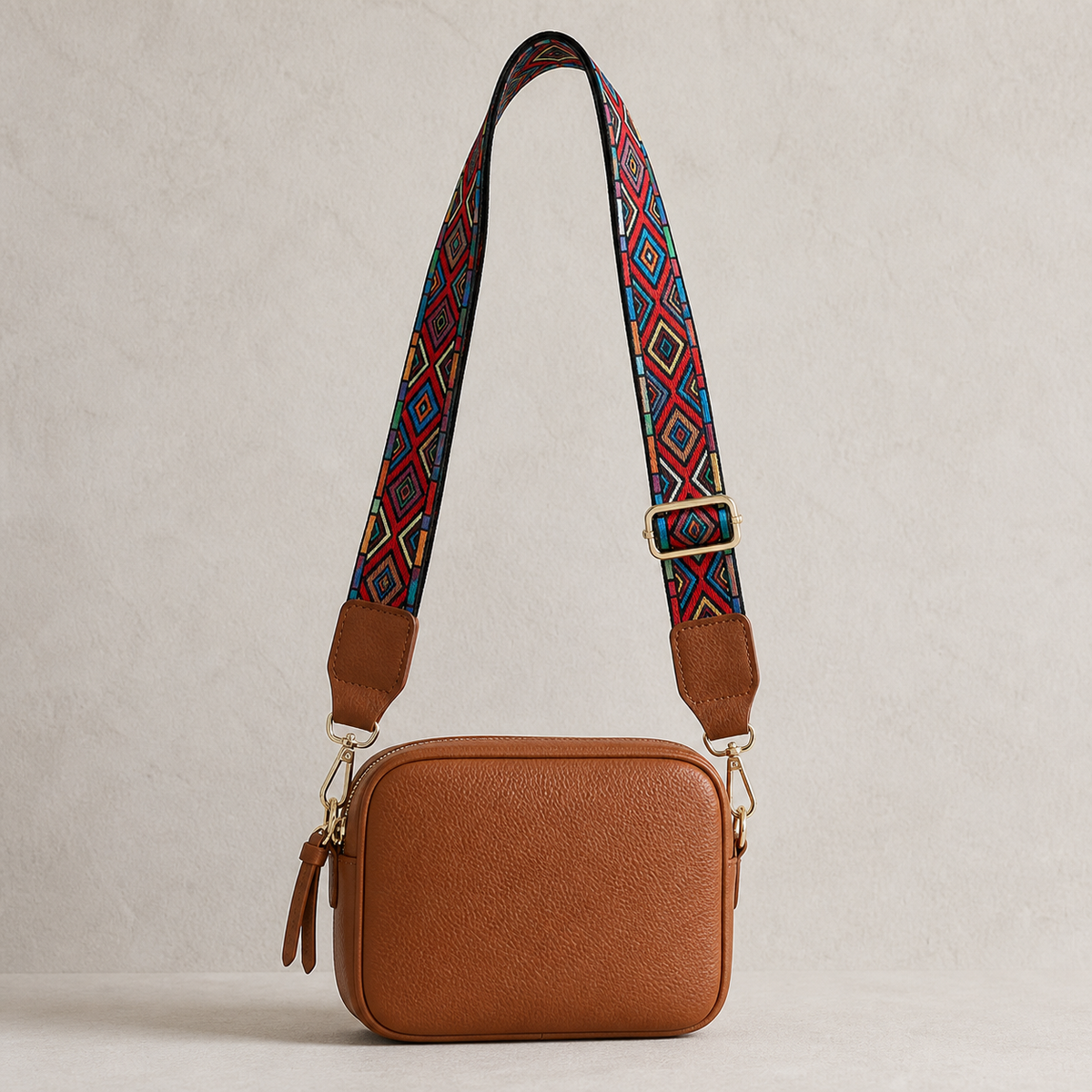 Carnival Diamond interchangeable strap styled on a cognac crossbody bag; bag not included
