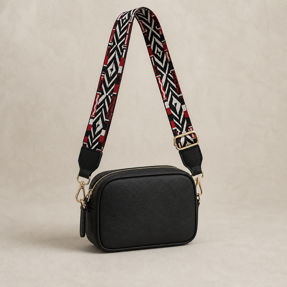 Crimson Tribal black-trim interchangeable strap styled on a black crossbody bag; bag not included