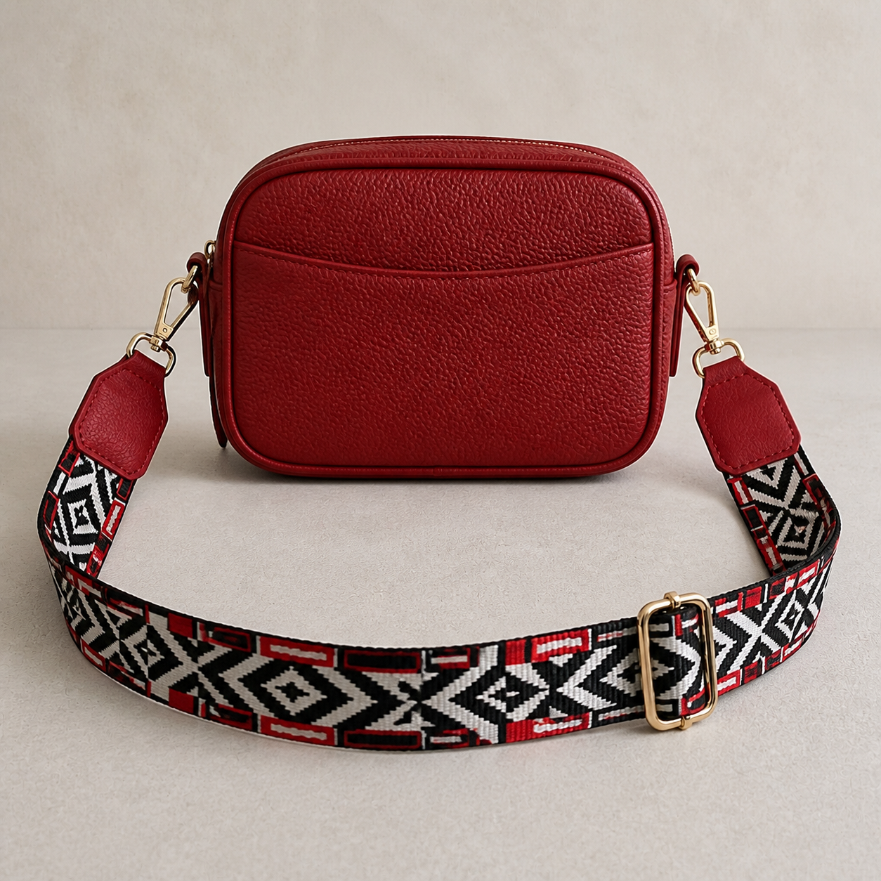 Crimson Tribal red trim bag strap attached to a red crossbody bag; bag not included