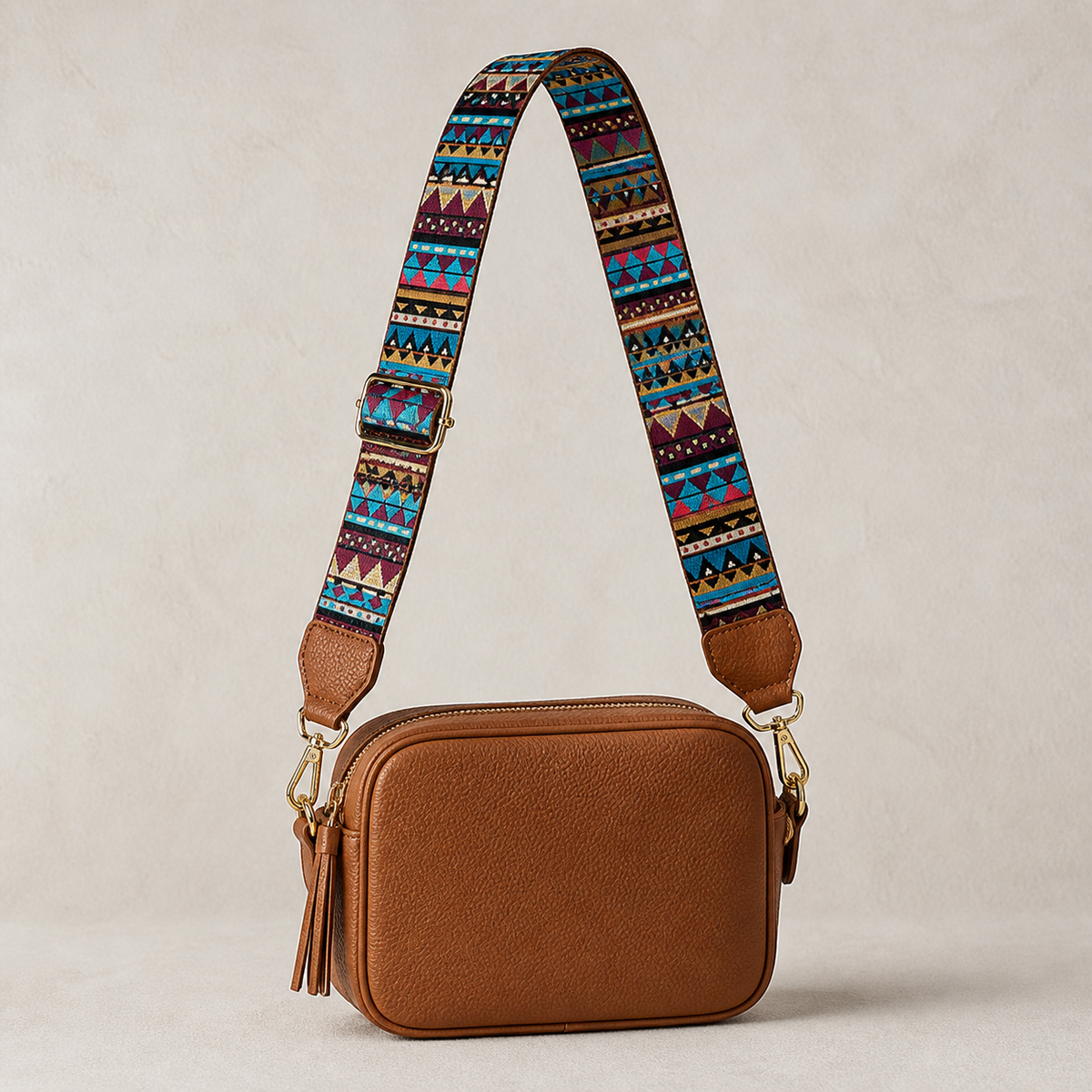 Desert Aztec interchangeable strap styled on a cognac crossbody bag; bag not included