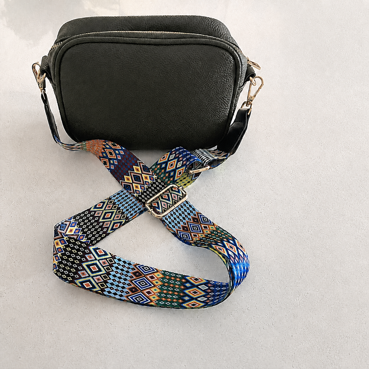Festival Mosaic bag strap attached to a black crossbody bag with no lettering; bag not included