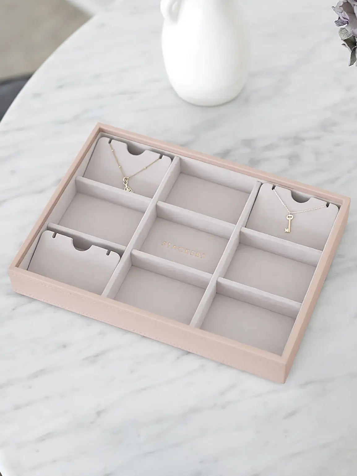 Stackers pendant necklace holders arranged inside a jewellery box layer. Jewellery and box sold separately.