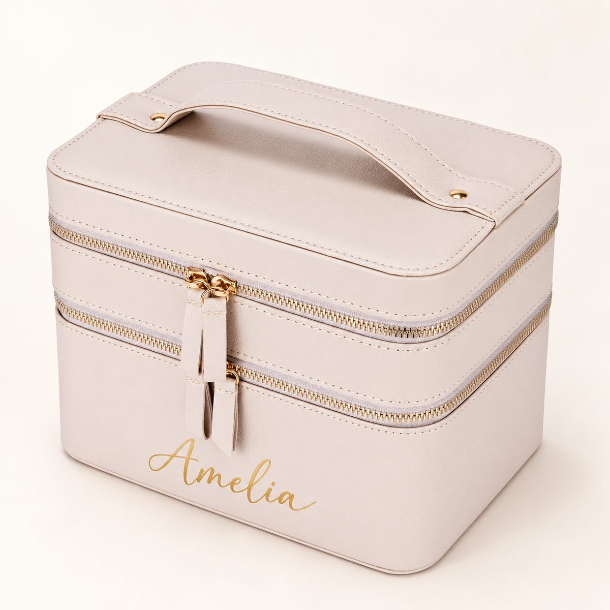 Angled beige travel makeup case mockup with example Amelia name in gold and top carry handle