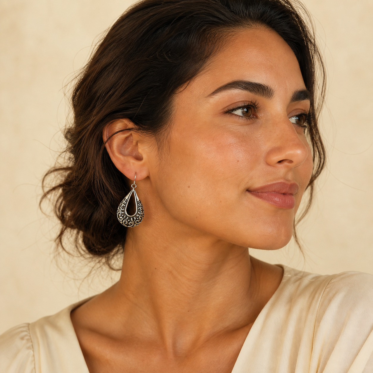 Young adult woman wearing PJ Luxe vintage filigree teardrop sterling silver earrings
