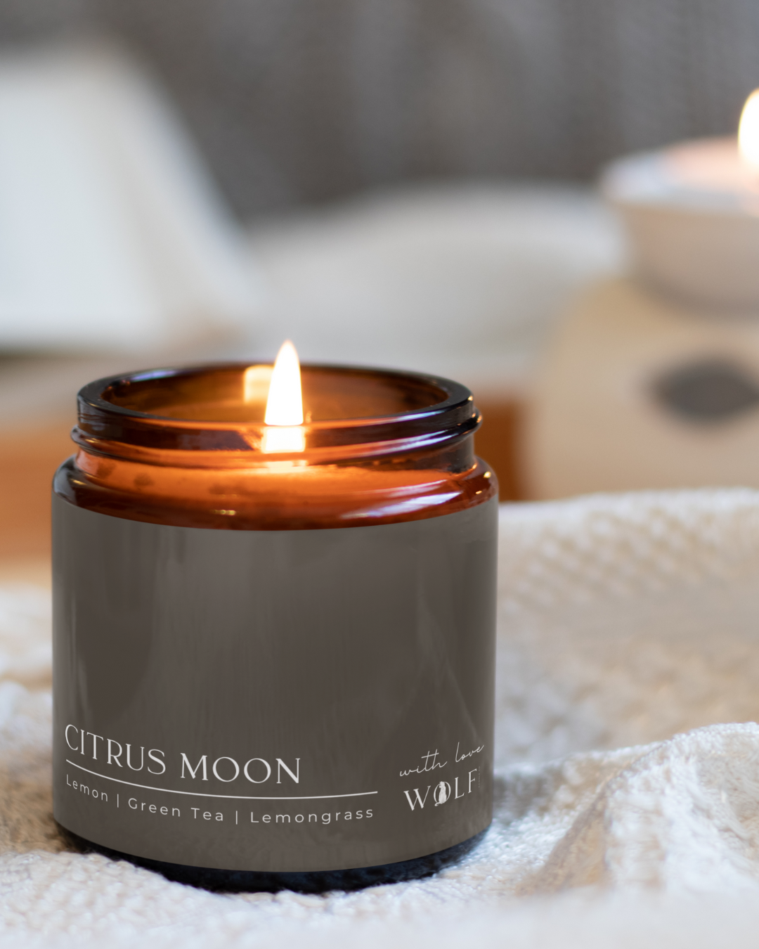 Citrus Moon candle styled in a warm bedroom setting