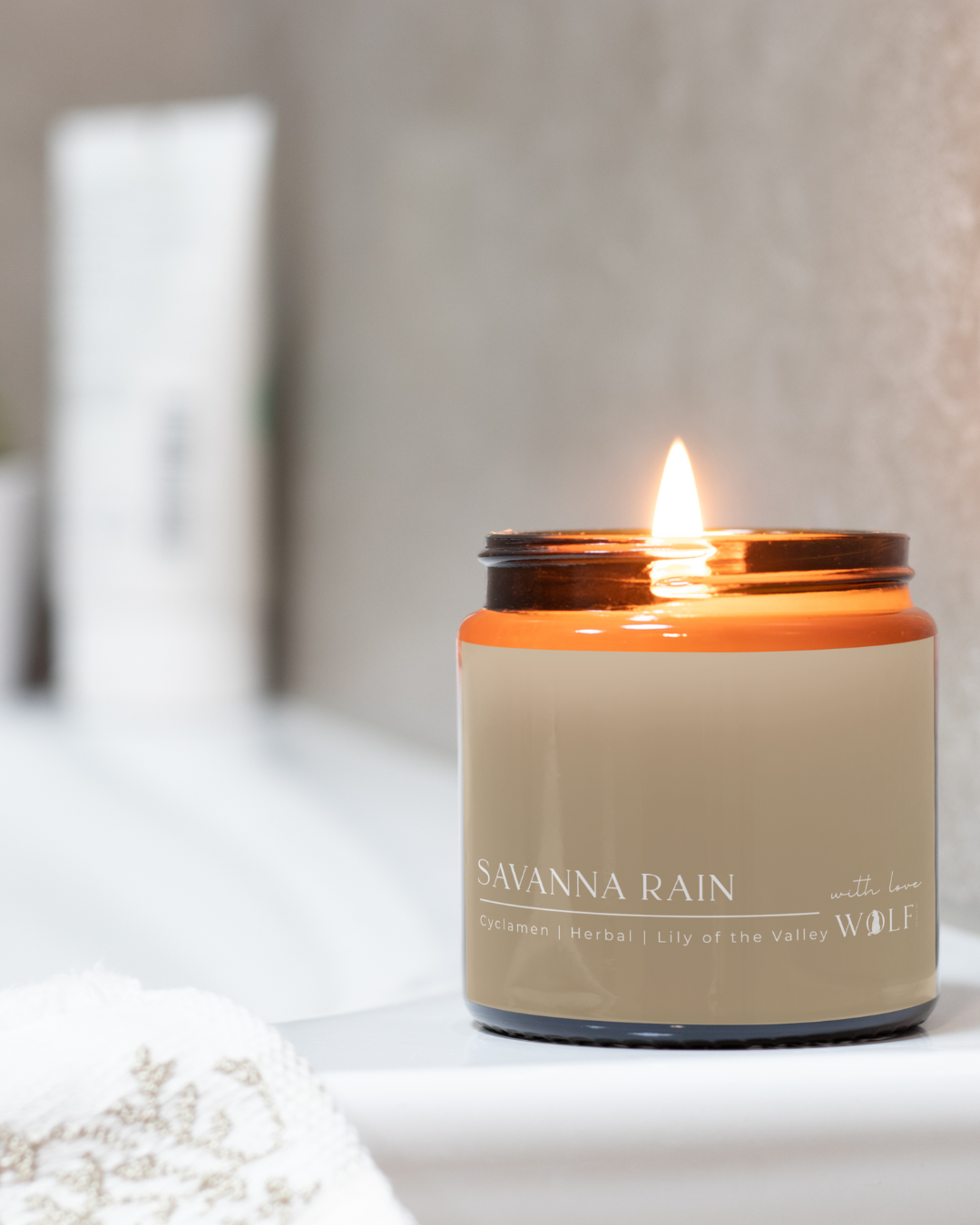 Savanna Rain candle styled in a calm bathroom setting